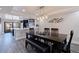 Dining area with a modern table and chairs, stylish lighting, and open access to the kitchen at 120 1St E St # 109, Tierra Verde, FL 33715