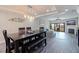 Inviting dining area with modern lighting and dining table, seamlessly connects to a cozy living room at 120 1St E St # 109, Tierra Verde, FL 33715