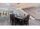 Dining room with a sleek table and chairs, flowing into a living room with a staircase nearby at 120 1St E St # 109, Tierra Verde, FL 33715