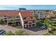 Exterior of a condo featuring a red tile roof, private garage, and well-maintained landscaping at 120 1St E St # 109, Tierra Verde, FL 33715