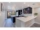 Modern kitchen features dark cabinets, quartz countertops, and an island with seating at 120 1St E St # 109, Tierra Verde, FL 33715