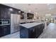 Modern kitchen featuring stainless steel appliances, a spacious island with white countertops and stylish pendant lighting at 120 1St E St # 109, Tierra Verde, FL 33715