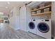 Convenient laundry area featuring a sliding door, ample shelving and modern washer and dryer at 120 1St E St # 109, Tierra Verde, FL 33715