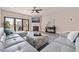 Living room with a modern sofa, decorative ottoman, fireplace, and balcony access at 120 1St E St # 109, Tierra Verde, FL 33715