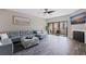 Living room featuring a stylish sectional sofa, modern decor, and access to an outdoor balcony at 120 1St E St # 109, Tierra Verde, FL 33715