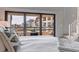 A cozy bedroom features a large sliding glass door to a balcony with views of nearby buildings at 120 1St E St # 109, Tierra Verde, FL 33715