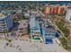 Stunning aerial view of the house with a pool and private beach access at 13303 Gulf Ln, Madeira Beach, FL 33708