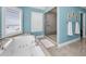 Bright bathroom featuring a soaking tub with beach views and a glass-enclosed shower at 13303 Gulf Ln, Madeira Beach, FL 33708