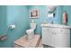 Bathroom featuring a white toilet, light-blue walls, and vanity with a mirror at 13303 Gulf Ln, Madeira Beach, FL 33708
