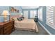Serene bedroom with a cozy bed, shuttered window, and elegant furnishings at 13303 Gulf Ln, Madeira Beach, FL 33708