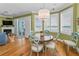 Cozy dining area with a round table, chandelier, and large windows overlooking the beach at 13303 Gulf Ln, Madeira Beach, FL 33708