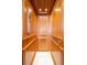 Private wood-paneled elevator with tile flooring and interior lighting at 13303 Gulf Ln, Madeira Beach, FL 33708