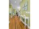 Inviting hallway with hardwood floors and coastal decor leading to various rooms at 13303 Gulf Ln, Madeira Beach, FL 33708