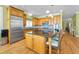 Spacious kitchen with wood cabinets, stainless steel appliances, granite counters, and a center island at 13303 Gulf Ln, Madeira Beach, FL 33708