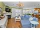Bright living room featuring a fireplace, sectional sofa, and sliding glass doors with ocean view at 13303 Gulf Ln, Madeira Beach, FL 33708