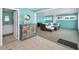Bright, open-concept living area with tile flooring, blue walls, and stylish furnishings at 13303 Gulf Ln, Madeira Beach, FL 33708
