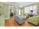 Living room featuring hardwood floors, olive green walls and stylish striped furniture at 13303 Gulf Ln, Madeira Beach, FL 33708