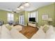 Cozy living area features comfortable seating, shuttered windows, and a flat-screen television at 13303 Gulf Ln, Madeira Beach, FL 33708