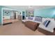 Open-concept living room featuring blue walls and a kitchen space with stainless steel appliances at 13303 Gulf Ln, Madeira Beach, FL 33708