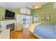 Comfortable main bedroom with fireplace, television, and sliding glass doors with ocean view at 13303 Gulf Ln, Madeira Beach, FL 33708