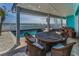 Covered patio with comfortable seating and ocean views, perfect for outdoor dining at 13303 Gulf Ln, Madeira Beach, FL 33708