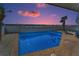 Beautiful backyard pool and patio, with a partial view of the ocean and sunset at 13303 Gulf Ln, Madeira Beach, FL 33708