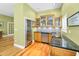 Wet bar with wine cooler, granite counters, glass-front cabinets, and stainless steel sink at 13303 Gulf Ln, Madeira Beach, FL 33708