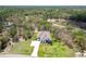 Expansive aerial view of a beautiful single-Gathering home with a long driveway, green lawns, and surrounded by lush greenery at 13334 Oldenburg Dr, Hudson, FL 34667