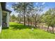 Expansive backyard features lush green grass with mature trees and view of natural surroundings at 13334 Oldenburg Dr, Hudson, FL 34667