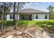 Covered patio seating with grill overlooks the backyard of this well-maintained home at 13334 Oldenburg Dr, Hudson, FL 34667