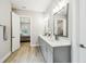 Elegant bathroom with dual sinks, marble countertops, and a view into the bedroom at 13334 Oldenburg Dr, Hudson, FL 34667