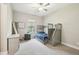 Bright bedroom featuring a bunk bed, carpeted floor, and a window that provides a view of the outdoors at 13334 Oldenburg Dr, Hudson, FL 34667