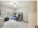 Bright bedroom featuring a bunk bed, carpeted floor, and a window that provides a view of the outdoors at 13334 Oldenburg Dr, Hudson, FL 34667