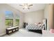 Cozy bedroom with a window bench, providing storage underneath, and a bed dressed in black and white at 13334 Oldenburg Dr, Hudson, FL 34667