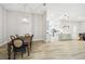 Elegant dining area with a dark wood table, stylish chairs, and a modern chandelier at 13334 Oldenburg Dr, Hudson, FL 34667