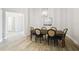 Bright dining room featuring a wooden table with seating for six and modern light fixture at 13334 Oldenburg Dr, Hudson, FL 34667