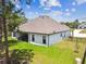 Aerial view of home with covered patio overlooking the backyard and mature landscaping at 13334 Oldenburg Dr, Hudson, FL 34667