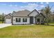 Beautiful single-story home featuring stone accents, a well-manicured lawn, and a welcoming entrance at 13334 Oldenburg Dr, Hudson, FL 34667