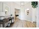 Spacious foyer features wood flooring, a decorative mirror, and an open view to the living room at 13334 Oldenburg Dr, Hudson, FL 34667