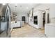 Spacious open kitchen featuring stainless steel appliances, white cabinetry, and wood look flooring at 13334 Oldenburg Dr, Hudson, FL 34667