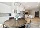 Bright kitchen with a stainless steel refrigerator, dining nook, and white cabinets at 13334 Oldenburg Dr, Hudson, FL 34667