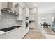 Bright kitchen with white cabinets, stainless steel appliances, and adjacent dining area with natural light at 13334 Oldenburg Dr, Hudson, FL 34667