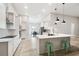 Bright open kitchen featuring white cabinets, stainless steel appliances, and large island with seating at 13334 Oldenburg Dr, Hudson, FL 34667