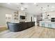 Bright living room flows into a modern kitchen with a center island and pendant lighting at 13334 Oldenburg Dr, Hudson, FL 34667