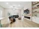 Spacious living room with a stacked stone accent wall and modern fireplace, perfect for entertaining at 13334 Oldenburg Dr, Hudson, FL 34667