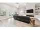 Inviting living area featuring a stylish stone fireplace, comfortable seating, and natural light at 13334 Oldenburg Dr, Hudson, FL 34667