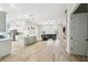 Spacious living room with wood floors, a fireplace, and an open layout connecting to the kitchen at 13334 Oldenburg Dr, Hudson, FL 34667