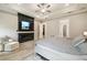 Spacious main bedroom with a tray ceiling and modern fireplace feature and access to an ensuite bathroom at 13334 Oldenburg Dr, Hudson, FL 34667