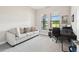 Bright home office with ample natural light, a comfortable seating area, and calming neutral walls at 13334 Oldenburg Dr, Hudson, FL 34667