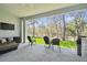 Covered patio with outdoor seating, a built-in grill, and a view of the lush backyard at 13334 Oldenburg Dr, Hudson, FL 34667